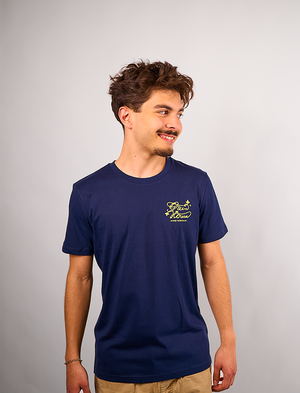 Man wearing a navy blueCreators of Champions T-shirt Blue-Yellow with a yellow logo on a plain background