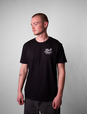 Man wearing a Creators of Champions T-shirt White Widow with a logo on a gray background