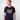 Man wearing a navy blue Green House t-shirt with white text and graphics on a plain background