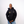 Person wearing a black Green House X Patta hoodie with logos on a white background