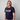 Person wearing a navy blue t-shirt with 'Strain Hunters' logo on a plain background
