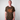 Person wearing a GH T-Shirt camouflage t-shirt with orange text on a plain background