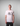 Man wearing a white Greenhouse Amsterdam t-shirt with text on a gray background