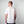 Man wearing a white t-shirt with a logo on the back against a plain background