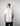 Man wearing a white t-shirt with a logo on the back against a plain background
