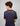 Person wearing a navy blue Green House Feeding t-shirt with 'keep it simple!' text on the back against a gray background