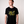 Man wearing a black t-shirt with Green House Logo - YELLOW
