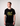Man wearing a black t-shirt with Green House Logo - YELLOW
