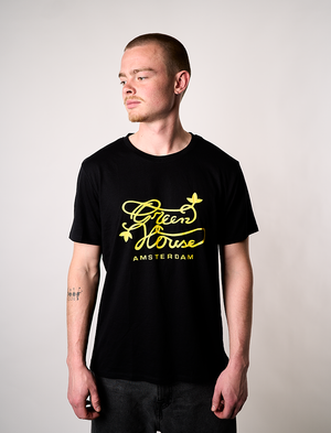 Man wearing a black t-shirt with Green House Logo - YELLOW
