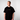 Man wearing a black t-shirt with a yellow logo on a plain background