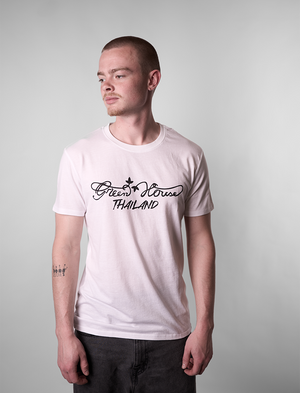Man wearing a white Green House Thailand t-shirt with black text on a plain background