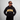 Person wearing a black hoodie with 'Greenhouse Coffee' text on a gray background