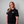 Person wearing a Green House World Cities T-Shirt Black with a logo on a gray background