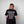Person wearing Green House World Cities T-Shirt Black with white text on the back against a gray background