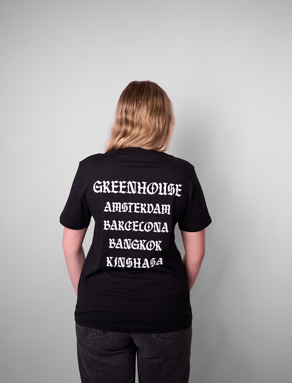 Person wearing Green House World Cities T-Shirt Black with white text on the back against a gray background