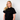 Person wearing a black t-shirt withTHE Green House and Propaganda Logo
