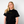 Person wearing a black t-shirt withTHE Green House and Propaganda Logo