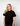 Person wearing a black t-shirt withTHE Green House and Propaganda Logo