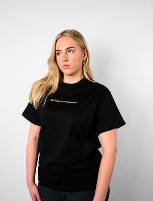 Person wearing a black t-shirt withTHE Green House and Propaganda Logo
