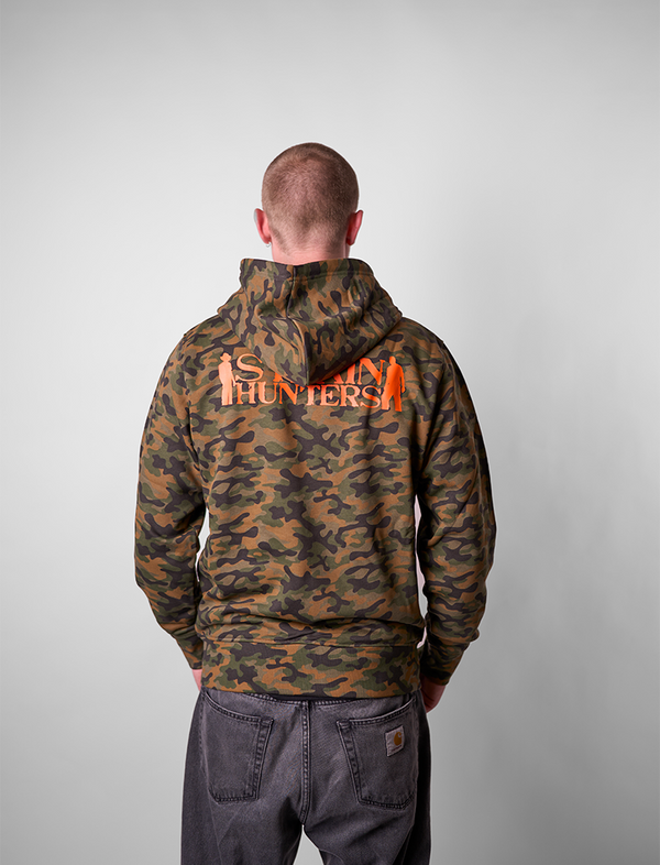 Man wearing a camouflage STRAIN HUNTERS hoodie 