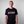 Person wearing a black t-shirt with 'Strain Hunters' logo on a plain background