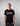 Person wearing a black t-shirt with 'Strain Hunters' logo on a plain background