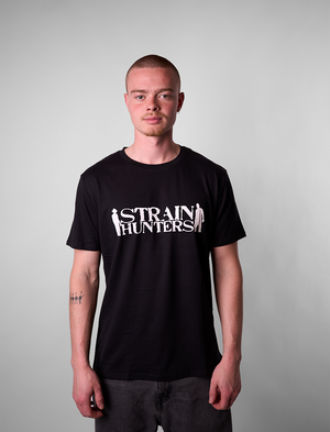 Person wearing a black t-shirt with 'Strain Hunters' logo on a plain background