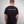 Man wearing a black t-shirt with 'GREENHOUSETHAILAND.COM' text on the back against a gray background