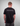Man wearing a black t-shirt with 'GREENHOUSETHAILAND.COM' text on the back against a gray background